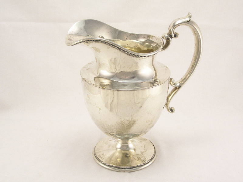 Appraisal: Sterling Water Pitcher Footed pitcher with beaded edge and scrolled