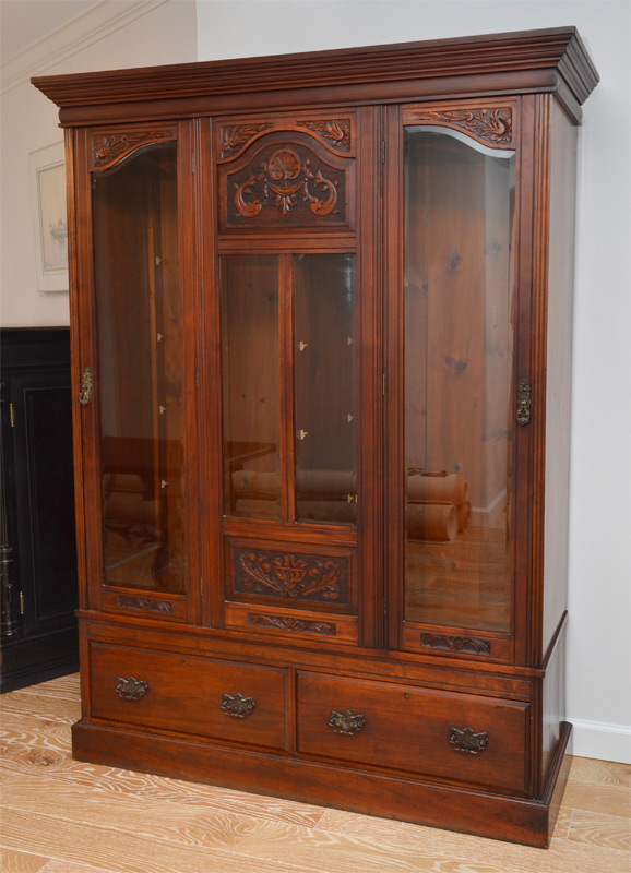 Appraisal: CARVED VICTORIAN WALNUT DISPLAY CABINET Stepped pediment center section with