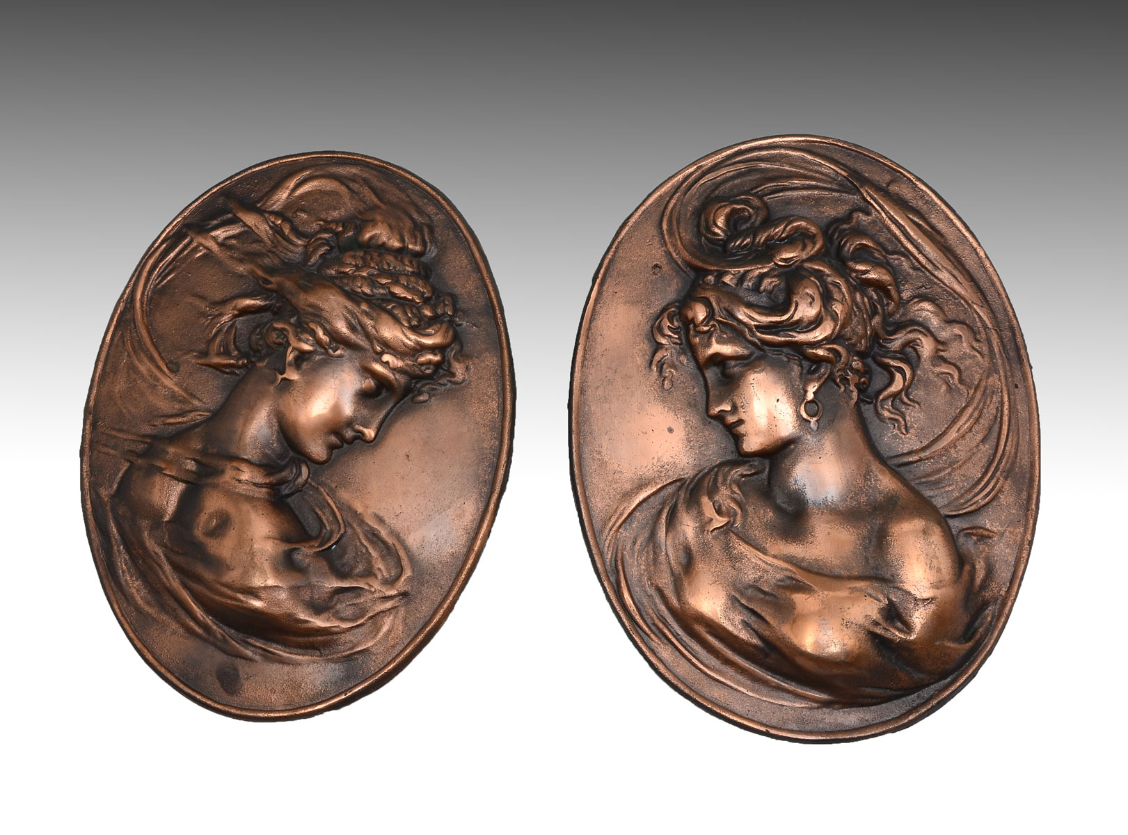 Appraisal: PAIR OF OPPOSING COPPER FEMALE BUST PLAQUES Art nouveau female