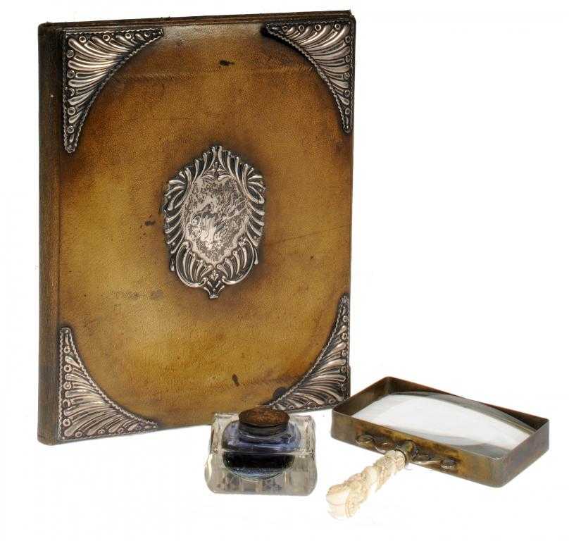 Appraisal: A VICTORIAN SILVER-MOUNTED MOROCCO LEATHER BLOTTING BOOK with spirally lobed