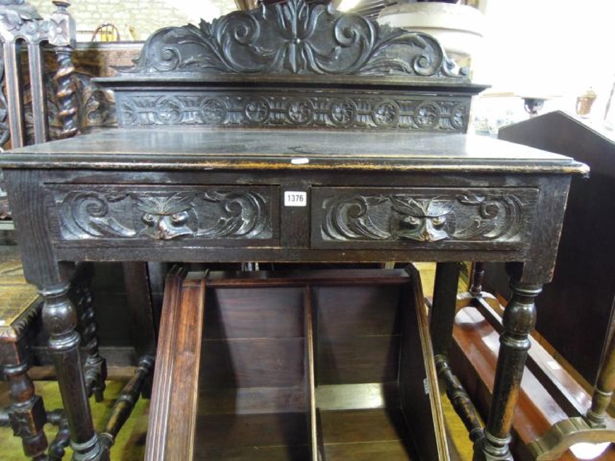 Appraisal: A late Victorian oak hall table with raised back over