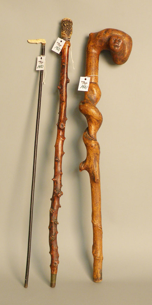 Appraisal: Root cane with carved animal mask grip together with two