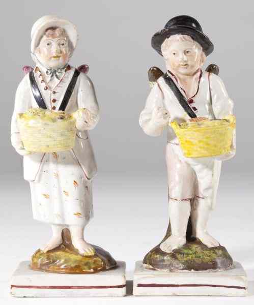 Appraisal: Pair of Early Staffordshire Winged Figurescirca two children a boy