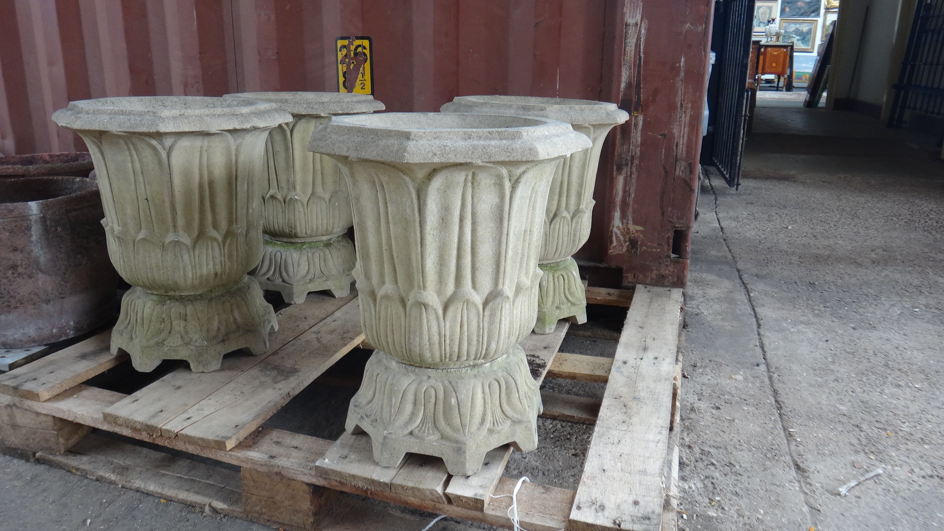 Appraisal: A set of four reconstituted stone planters of stylised tulip