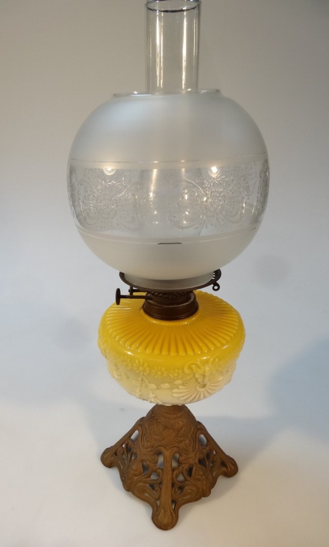 Appraisal: An Edwardian oil lamp with clear glass funnel and part