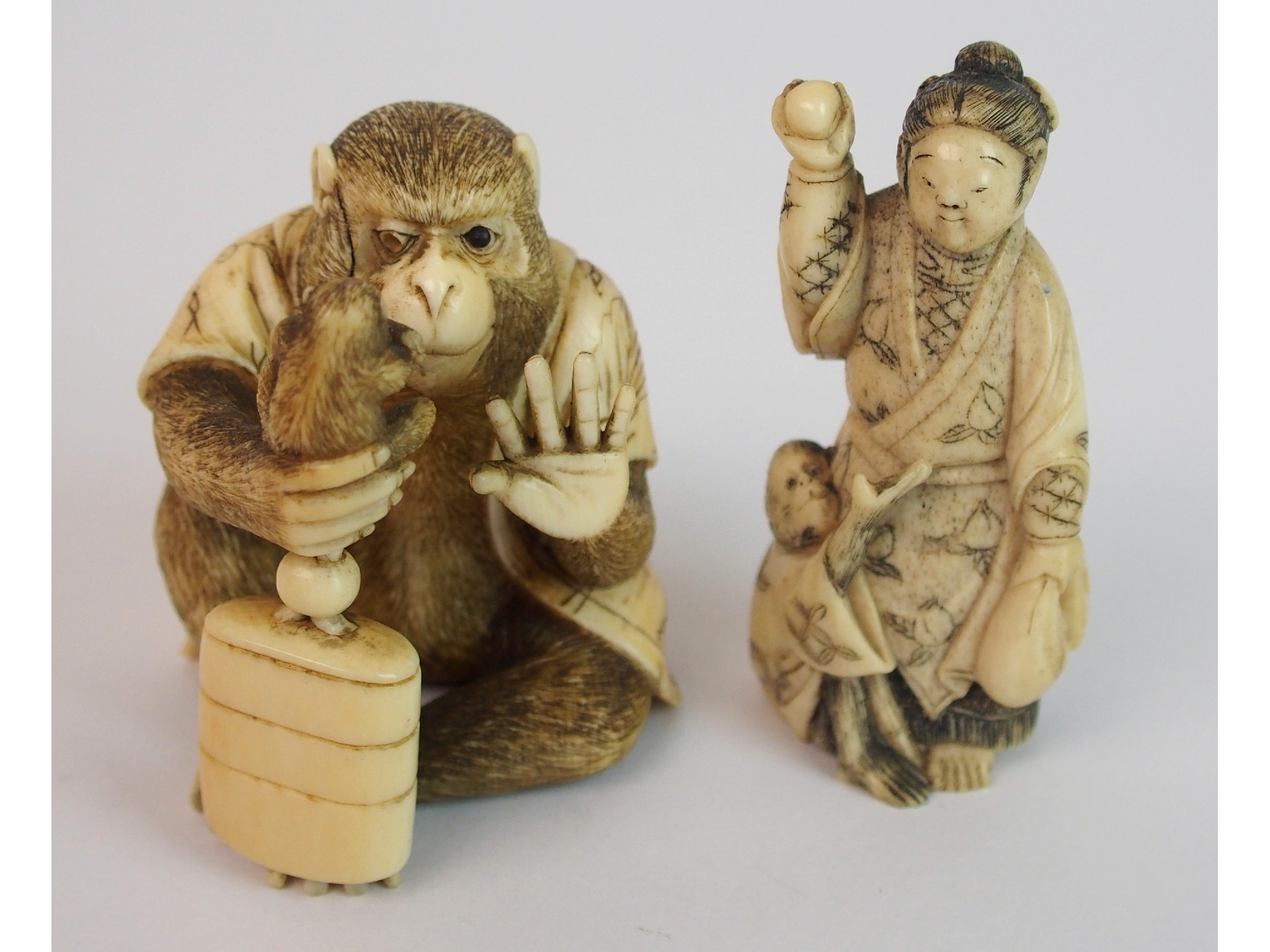 Appraisal: A Japanese okimono of a monkeyseated and holding a chimp