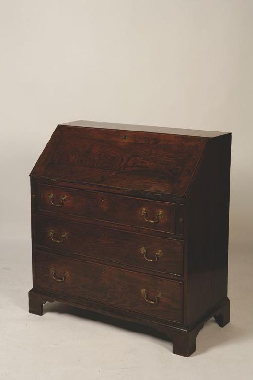 Appraisal: A GEORGE III BUREAU the sloping fall enclosing a fitted