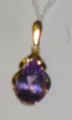 Appraisal: AN AMETHYST PENDANT the pear cut stone claw set beneath