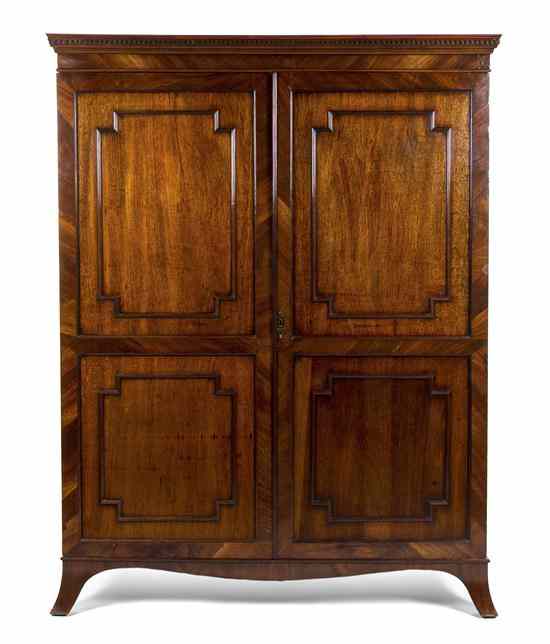 Appraisal: An English Mahogany Armoire having a dentiled cornice over two