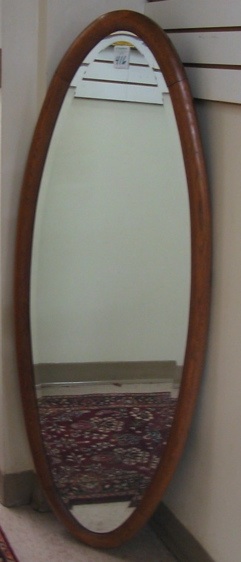 Appraisal: A LONG OVAL WALL MIRROR Belgian early th century the