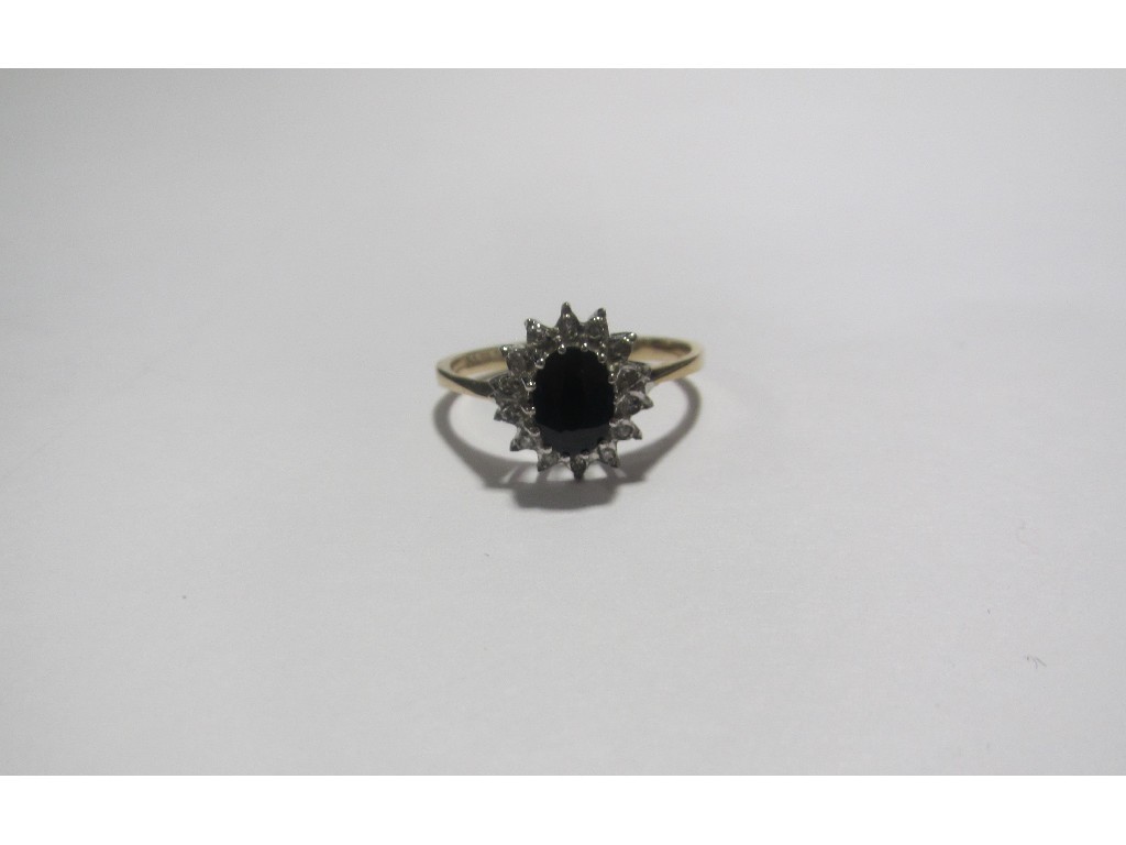 Appraisal: Nine carat gold sapphire and diamond cluster ring