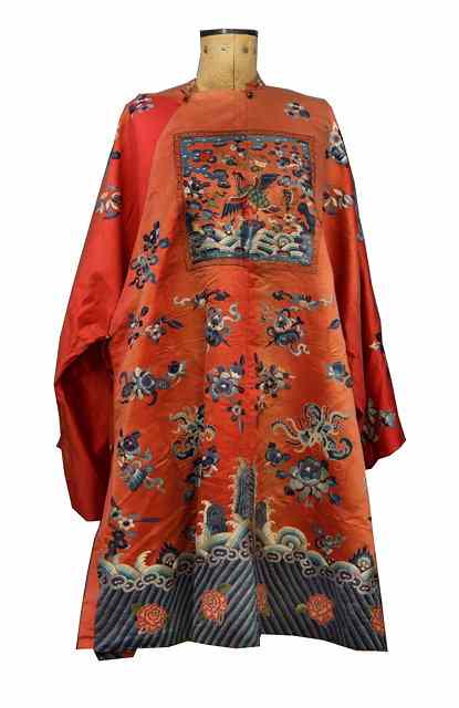 Appraisal: A CHINESE APRICOT SILK CEREMONIAL ROBE decorated symbolic birds and