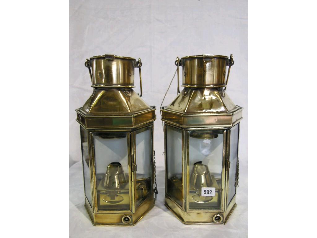 Appraisal: A pair of brass galley lamps with three glass panes