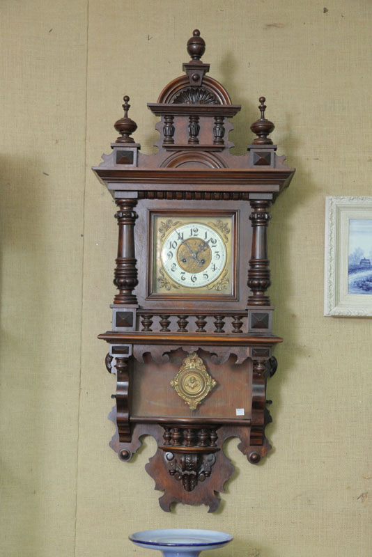 Appraisal: WALL CLOCK Eight day time strike with brass works and