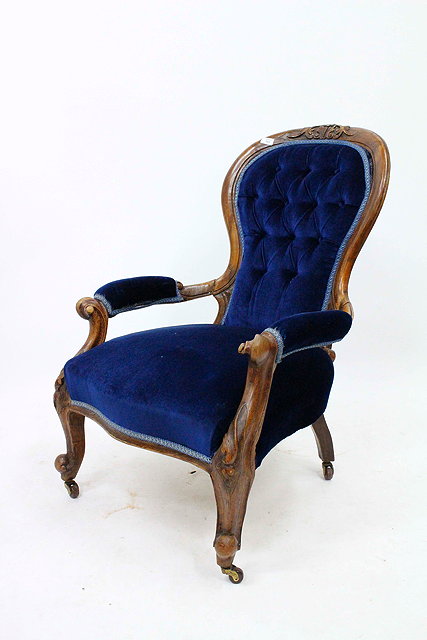 Appraisal: A VICTORIAN WALNUT OPEN ARMCHAIR with button upholstered spoon back