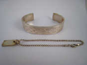 Appraisal: A white metal tests silver bangle marked Gucci together with