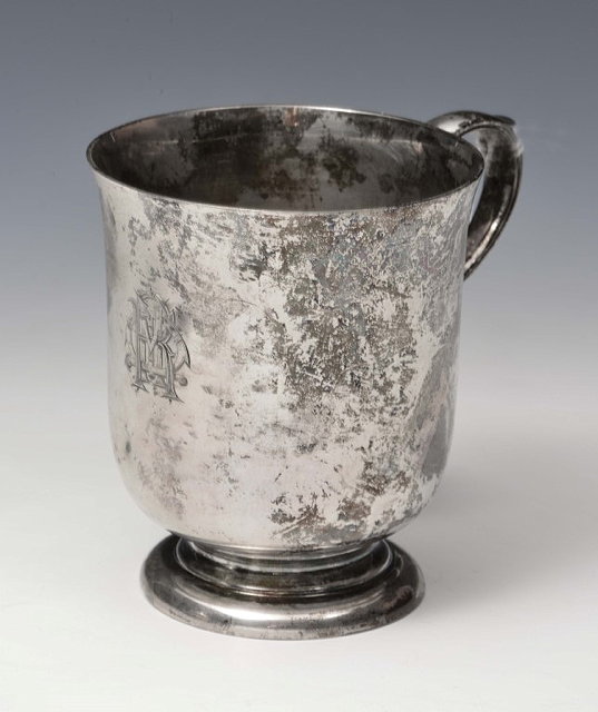 Appraisal: A SILVER CHRISTENING MUG of plain waisted form standing on