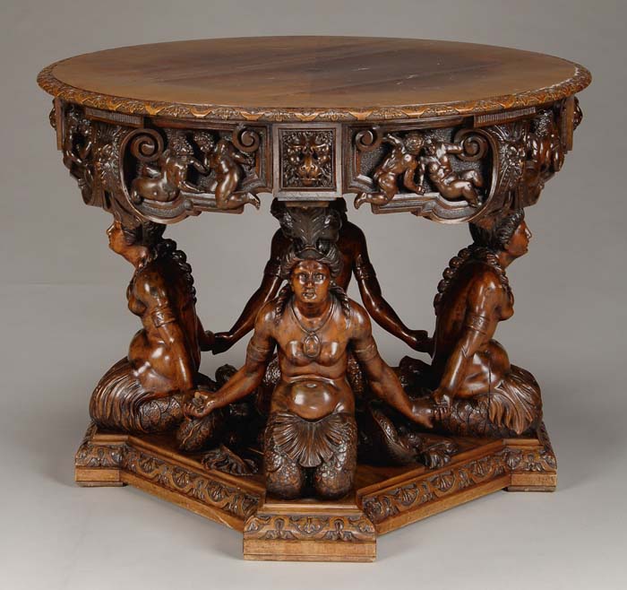 Appraisal: LAVISHLY CARVED WALNUT MERMAID CENTER TABLE Round matched veneer walnut