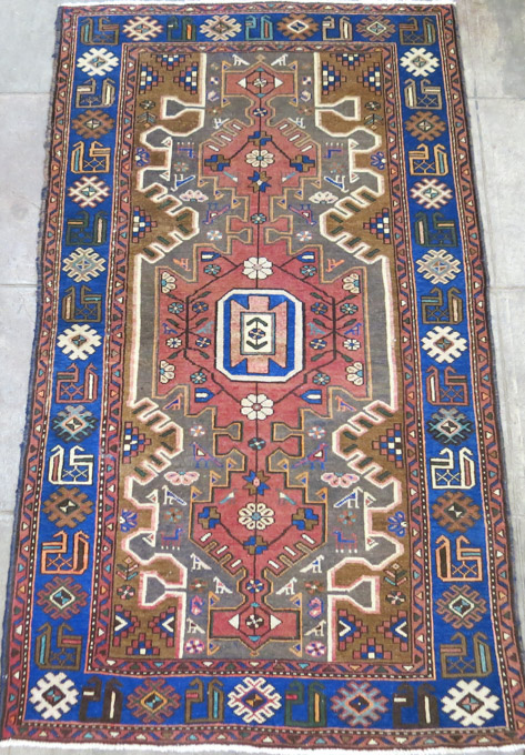 Appraisal: SEMI-ANTIQUE PERSIAN TRIBAL AREA RUG geometric medallion and stylized floral