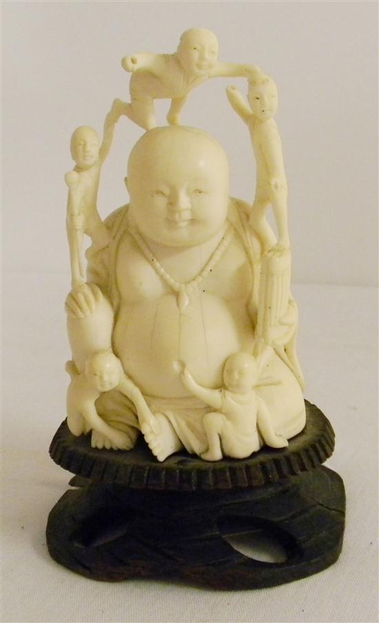 Appraisal: Budda carving with children mounted on wooden base approx ''