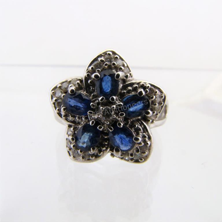 Appraisal: A K white gold flower design ring with sapphire and