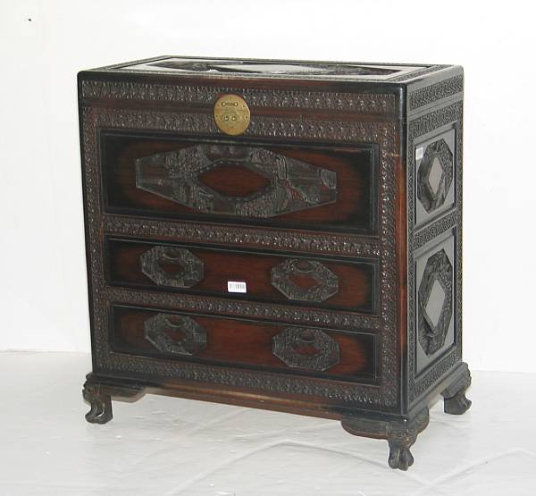 Appraisal: An elaborately carved export wood chest with hinged top over