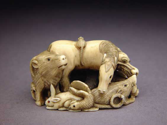 Appraisal: CARVED IVORY NETSUKE Contemporary carved ivory netsuke of the Twelve