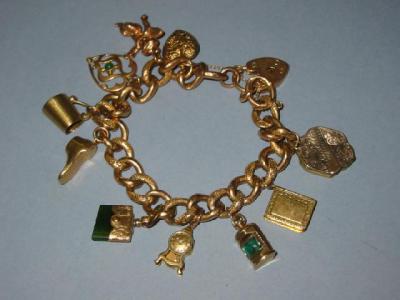 Appraisal: A CT GOLD CHARM BRACELET the hollow curb links hanging