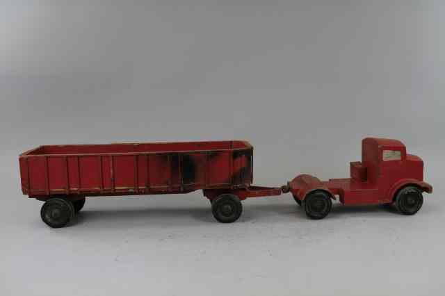 Appraisal: DIECAST TRUCK TRAILER AND DOLLY Heavily cast painted in red