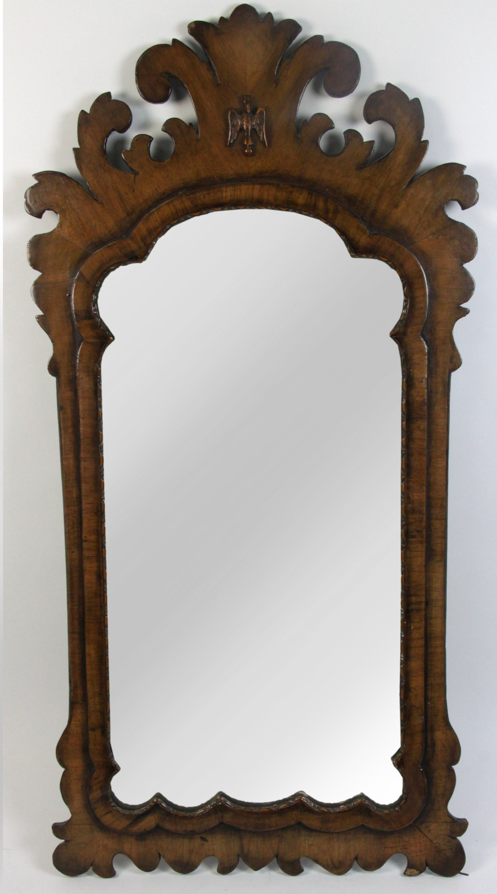 Appraisal: A George II style walnut framed fret carved wall mirror