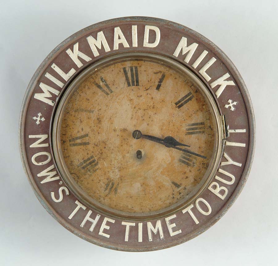 Appraisal: MILKMAID MILK CLOCK Baird style clock with embossed metal bezel