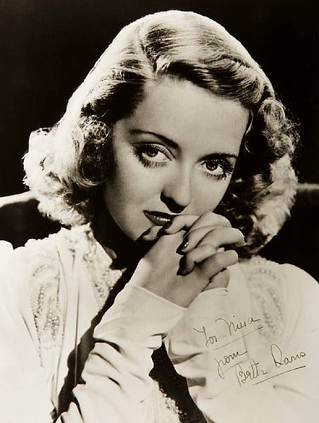 Appraisal: A Bette Davis signed black and white photograph s A