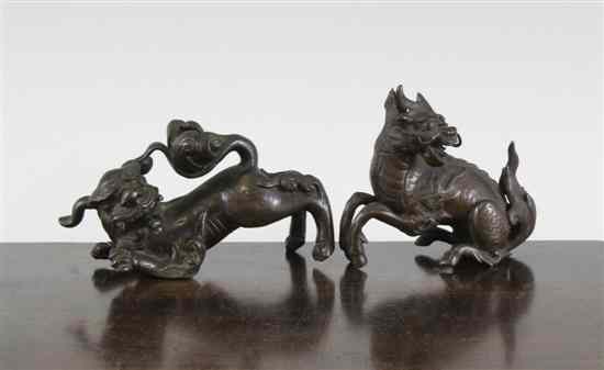 Appraisal: Two Chinese bronze scroll weights the first cast as a