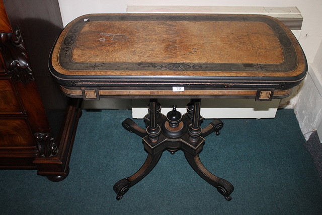 Appraisal: A VICTORIAN EBONISED AND AMBOYNA FOLD OVER CARD TABLE cm