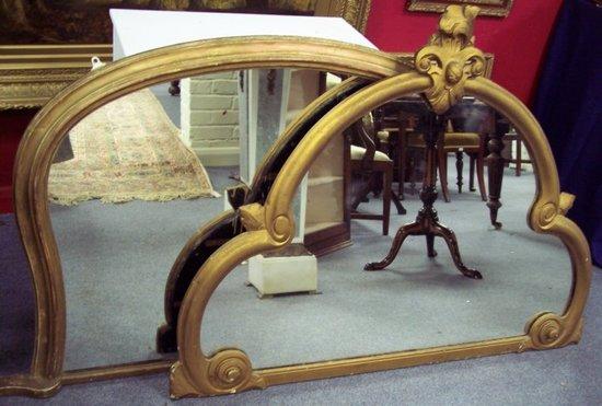 Appraisal: A carved gilt framed mirror of shaped outline the glass