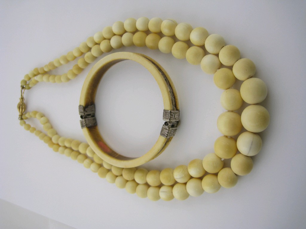 Appraisal: A two row graduated ivory bead Necklace with barrel clasp