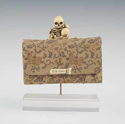 Appraisal: A Carved Skeleton Mounted Tobacco Pouch Japanese th Century A