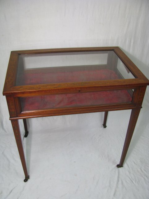 Appraisal: Marquetry inlay glass display case on castors Red velvet lined