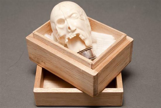 Appraisal: Continental carved ivory half-skull and half flesh human head late