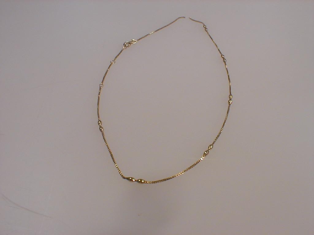 Appraisal: A yellow metal fancy neck chain with oval beads at