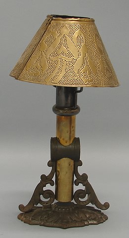 Appraisal: Signed removable bracket supporting punched brass shade scrolled cast iron