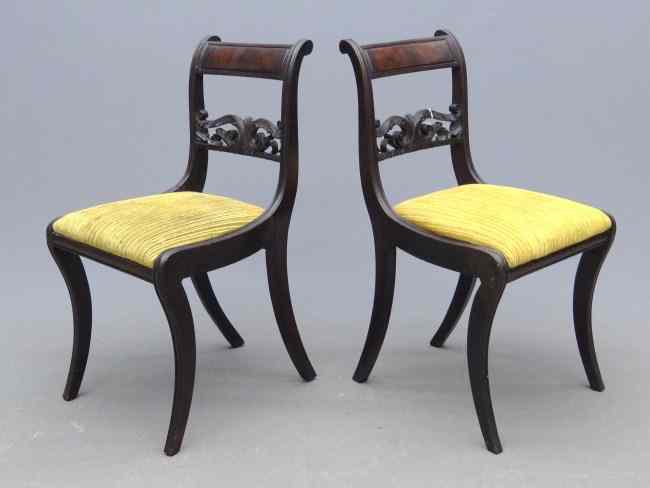 Appraisal: Pair th c Classical carved saber leg chairs '' Seat