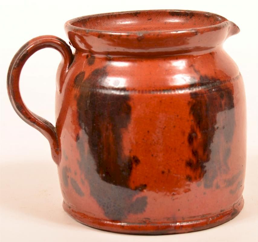 Appraisal: Pennsylvania Redware Pottery Pitcher Pennsylvania th Century Mottle glazed Redware