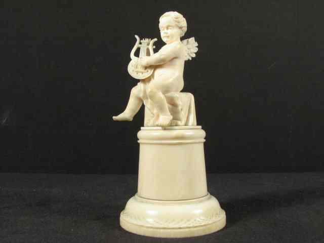 Appraisal: Continental carved ivory figure of an angel or Putti playing