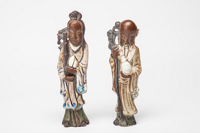 Appraisal: A PAIR OF CHINESE POTTERY PART GLAZED MODELS OF IMMORTALS