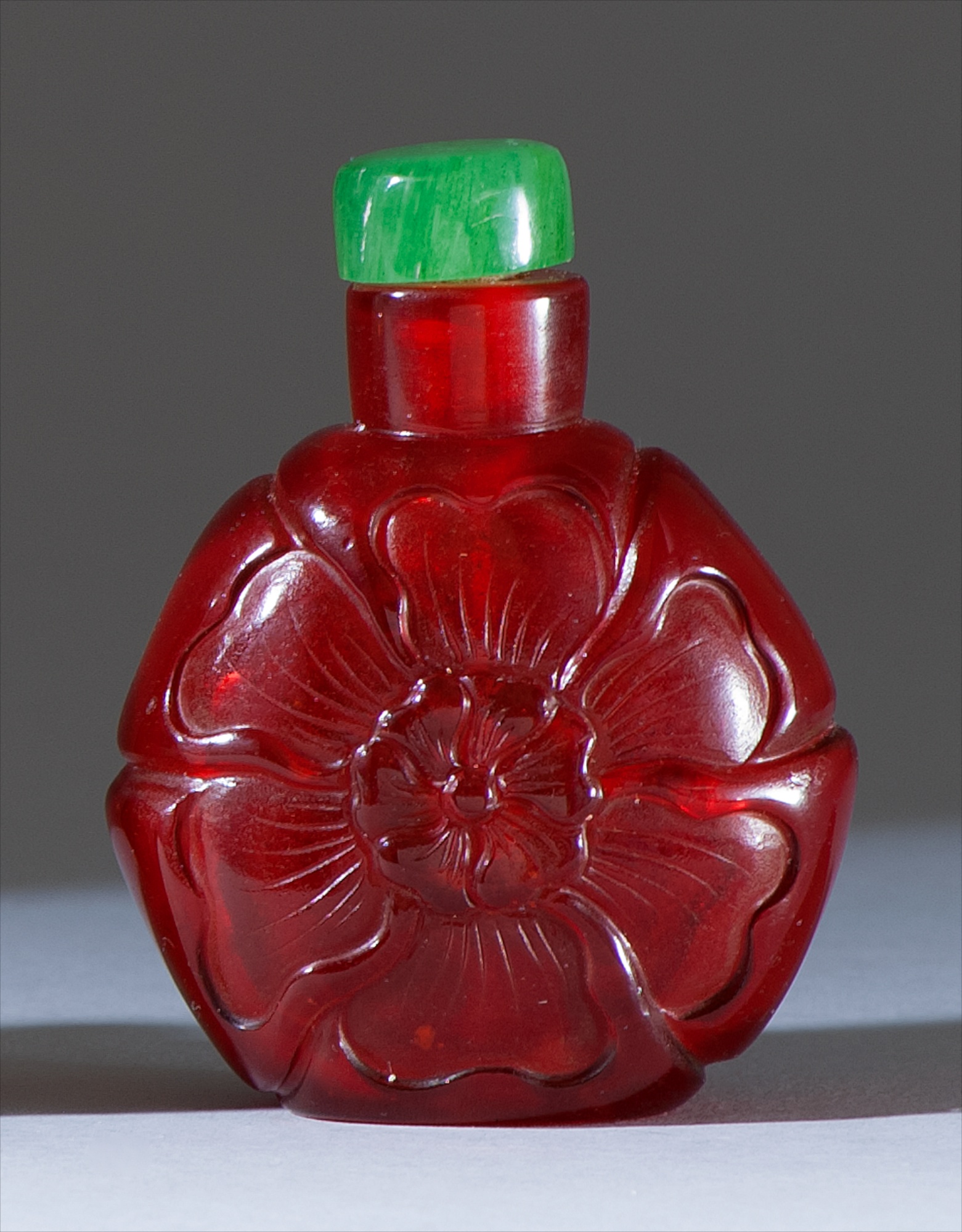 Appraisal: RED GLASS SNUFF BOTTLE Late th CenturyIn mallow flower form