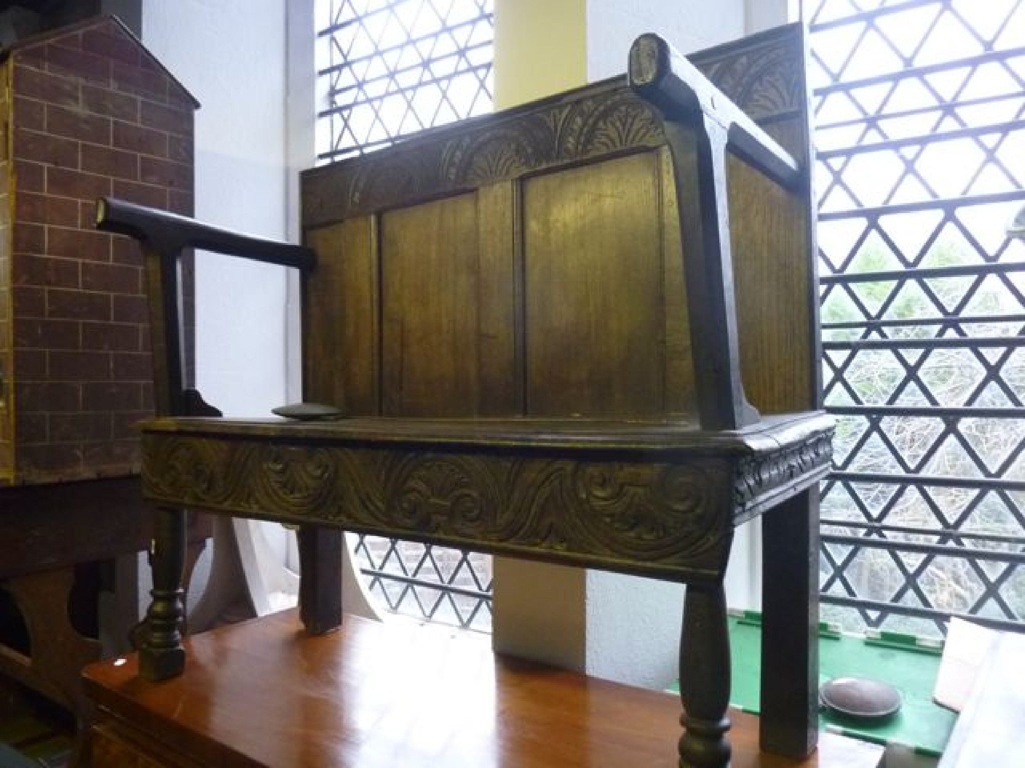 Appraisal: An small antique oak settle the raised moulded panelled back