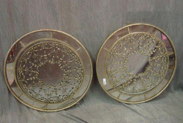 Appraisal: Pair of Patinated Metal Mirrors with Leaf Metalwork From a