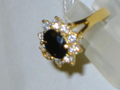 Appraisal: A SAPPHIRE DRESS RING comprising dark green oval sapphire surrounded