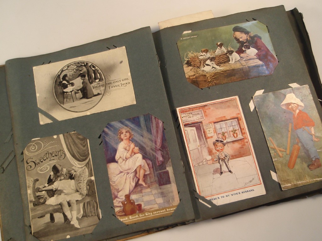 Appraisal: An early thC postcard album containing approximately cards including topographical